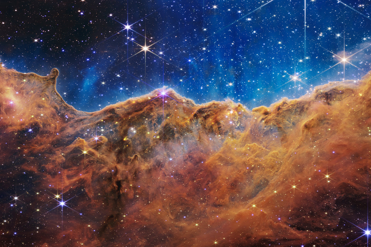 Cosmic Cliffs Carina Nebula JWST fine art print on Hahnemühle Baryta paper framed on a wall — warm red and orange tones of the nebula ridge on archival Baryta paper