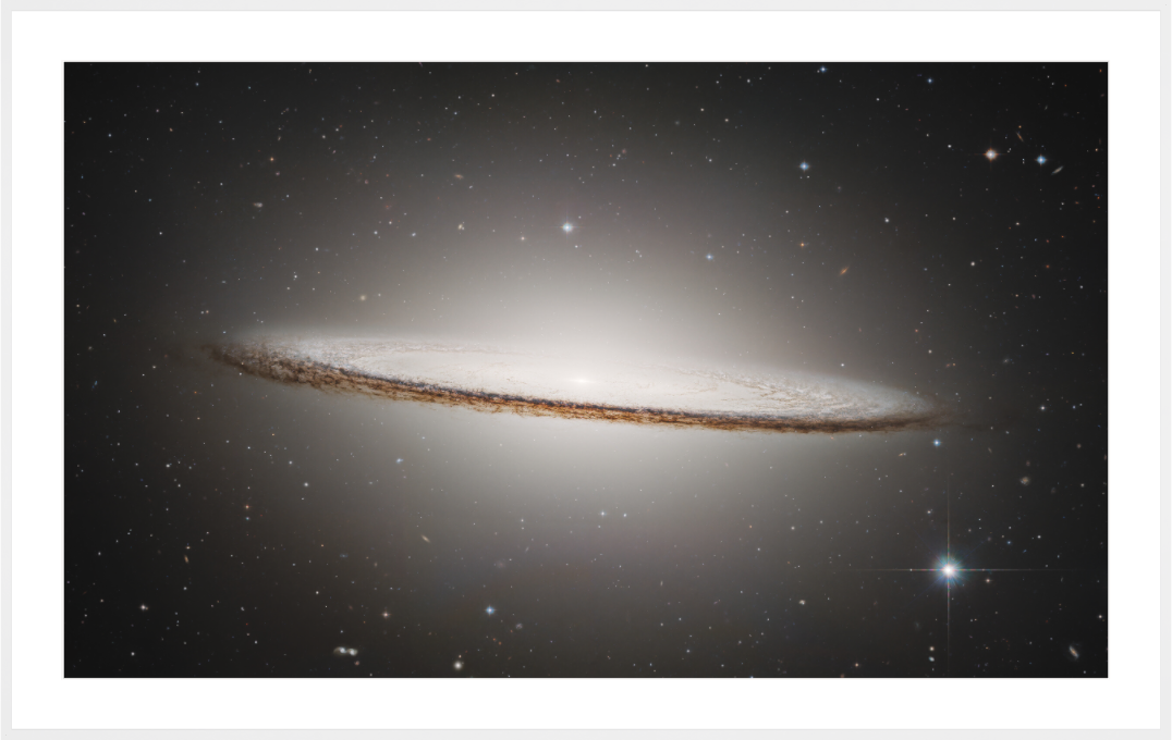 Sombrero Galaxy photographed by Hubble — glowing bulge and dark dust lane 
against deep space, ESA/Hubble & NASA
