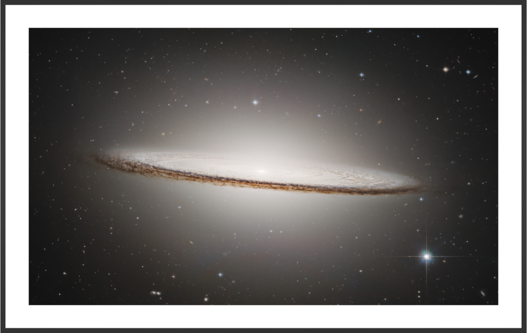 Sombrero Galaxy photographed by Hubble — glowing bulge and dark dust lane 
against deep space, ESA/Hubble & NASA