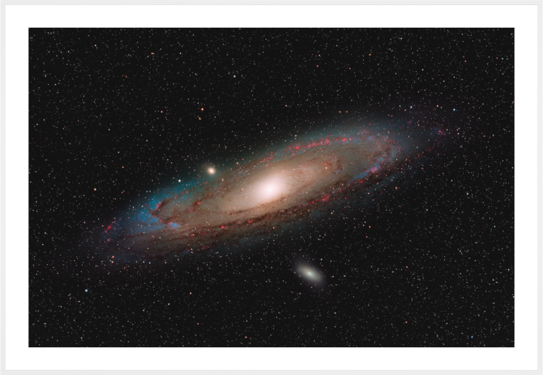 M31 Andromeda Galaxy with hydrogen alpha enhancement, fine art astrophotography print with White Frame by Sideris Art, photographed from the Colli Euganei, Italy